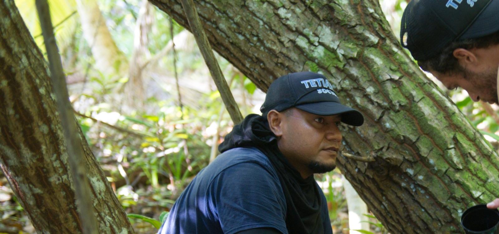 Lusiano working with a researcher on the mosquito project